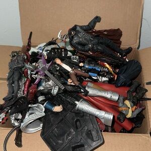 Box of old action figures with accessories